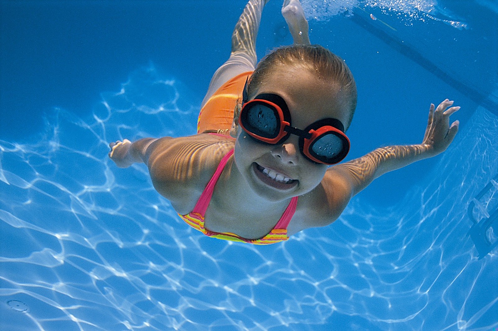 Young swimmer smiling underwater