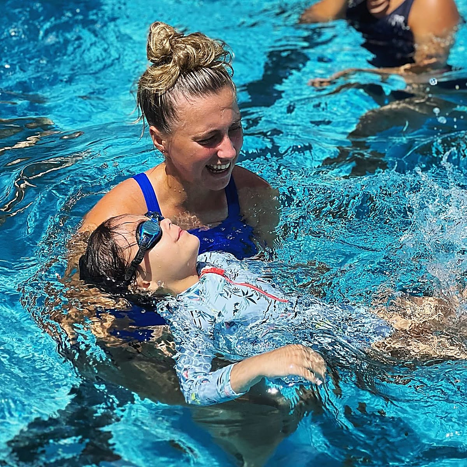Instructor with a child in the pool